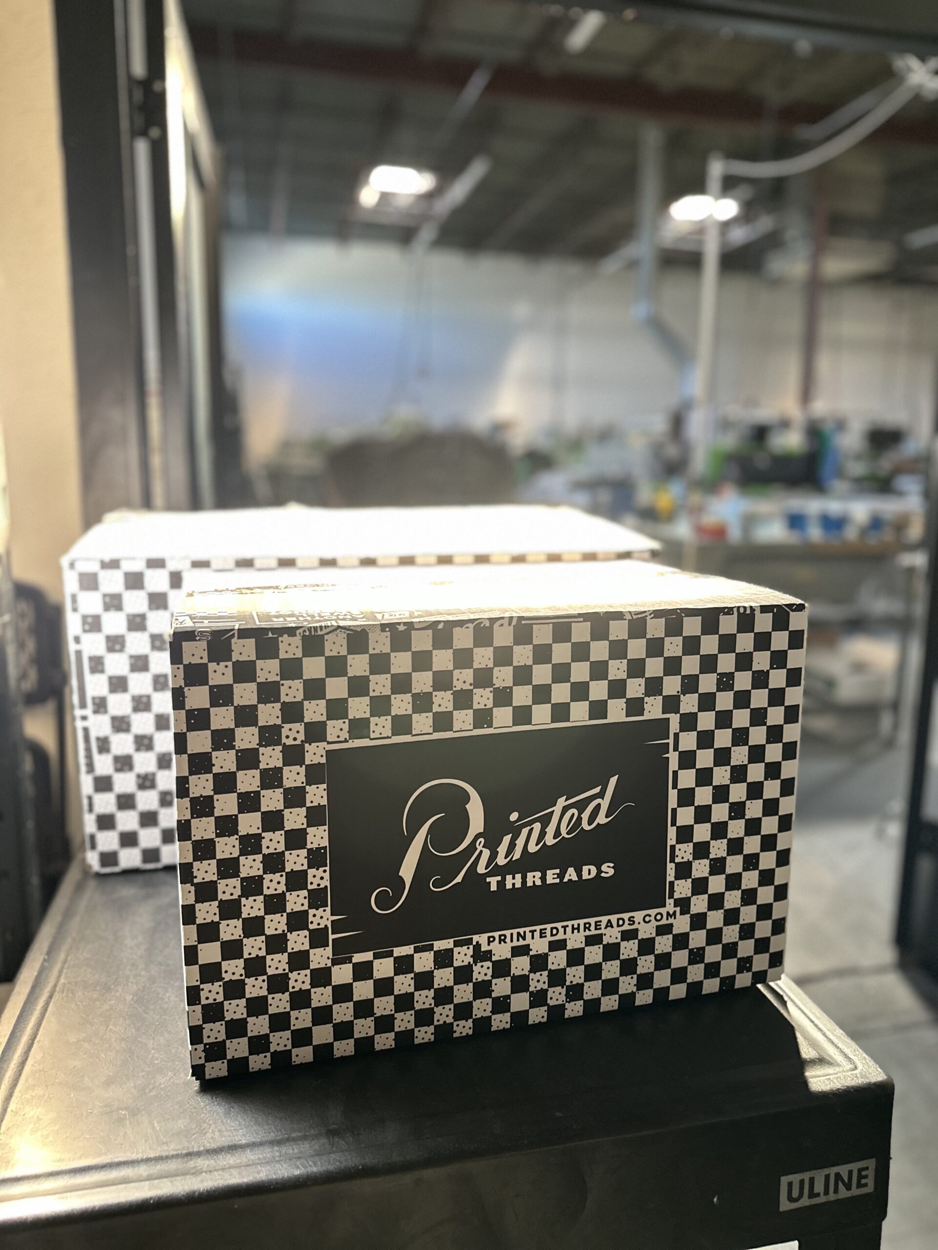 A Printed Threads box that shirts are shipped to customers in.